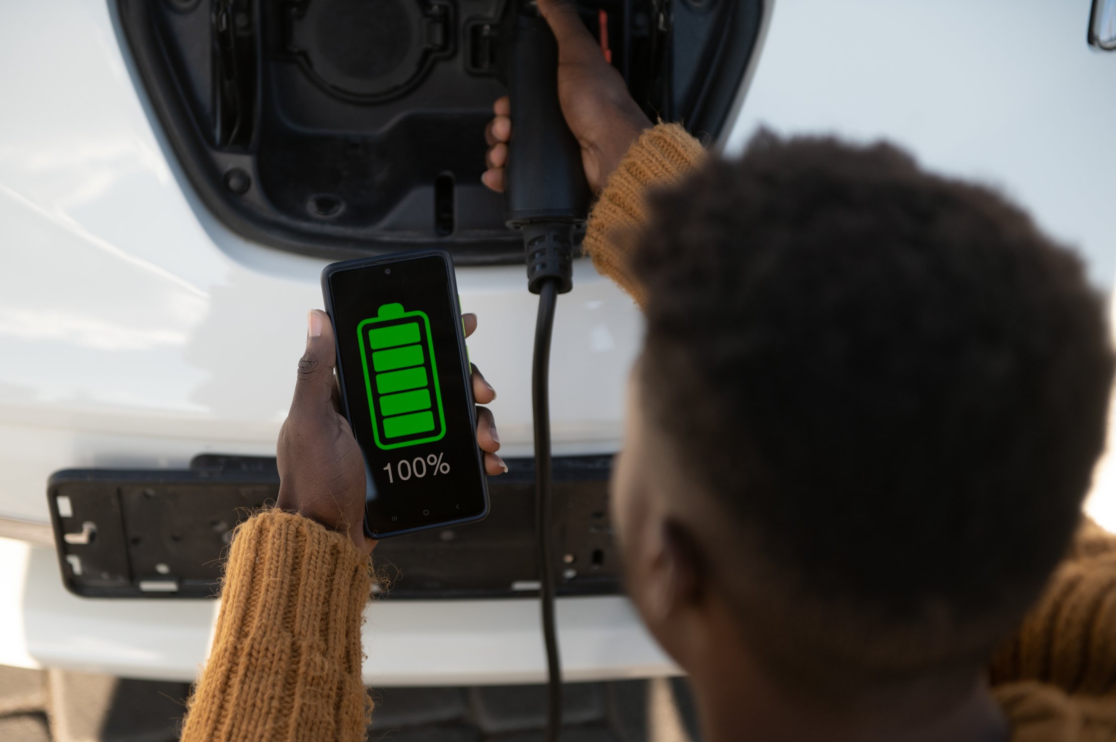 man-charging-his-electric-vehicle