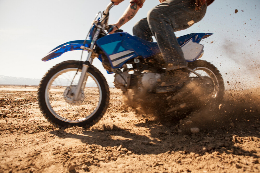 Man Riding Dirt Bike in Desert
